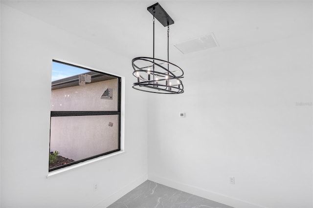 unfurnished dining area with a notable chandelier