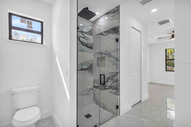 bathroom with ceiling fan, a shower with shower door, and toilet