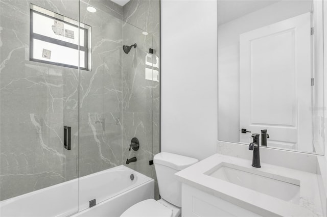 full bathroom with bath / shower combo with glass door, vanity, and toilet