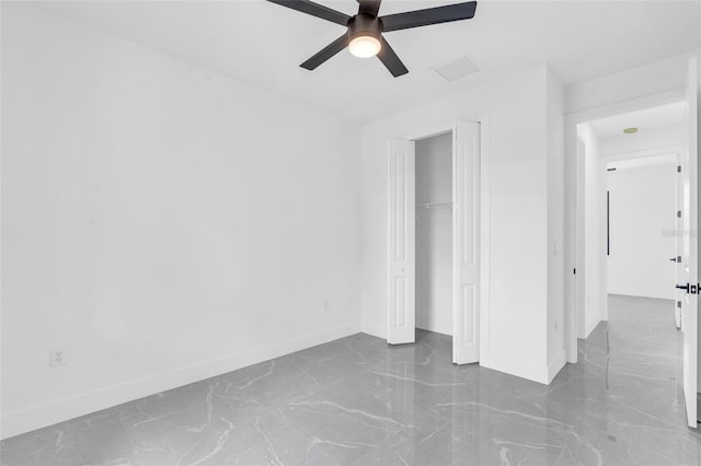 interior space with ceiling fan and a closet