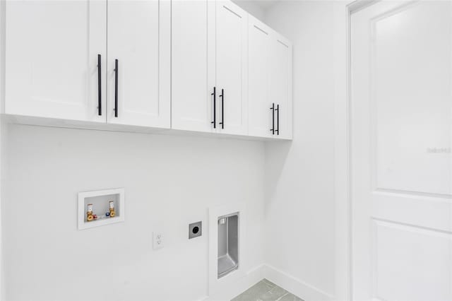 laundry area with electric dryer hookup, washer hookup, and cabinets