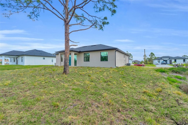 back of house with a lawn