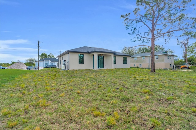 rear view of property with a lawn