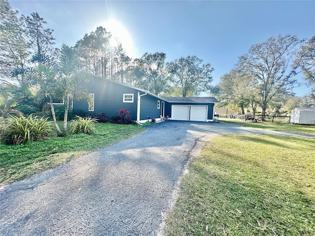 view of front of property featuring a garage and a front lawn