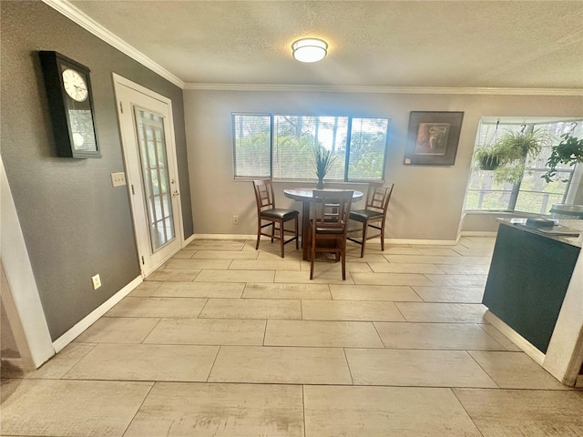 dining area featuring crown molding, plenty of natural light, and a textured ceiling