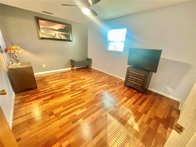 interior space featuring hardwood / wood-style floors and ceiling fan