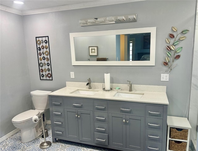 bathroom featuring tile patterned flooring, ornamental molding, vanity, and toilet