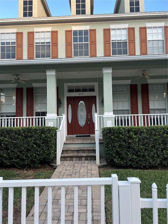 doorway to property featuring a porch and ceiling fan