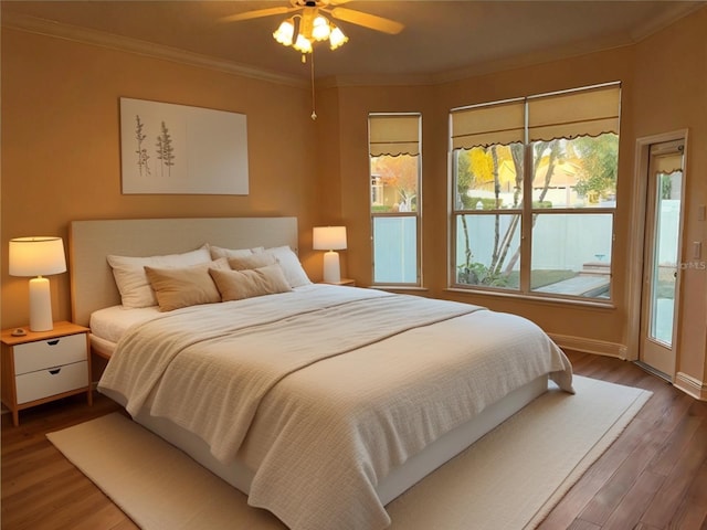 bedroom with crown molding, hardwood / wood-style floors, access to exterior, and ceiling fan