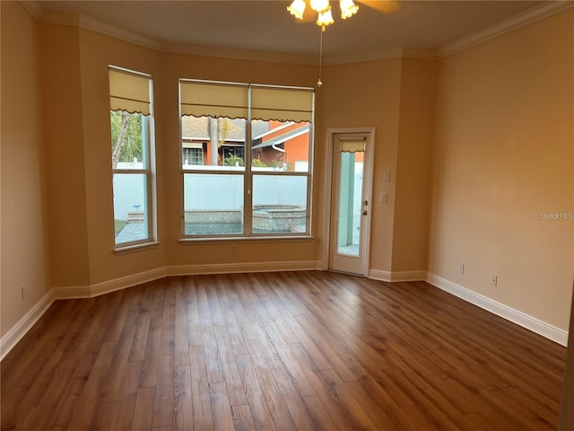 unfurnished room with ornamental molding and dark hardwood / wood-style floors