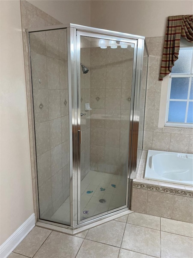 bathroom with tile patterned floors and plus walk in shower