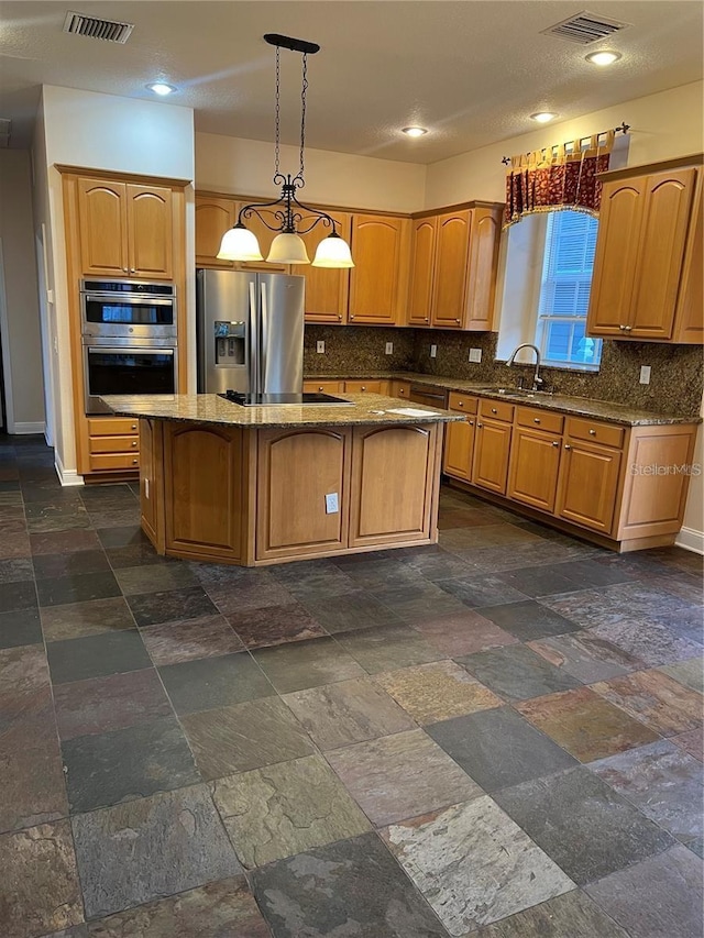 kitchen with stone countertops, a kitchen island, pendant lighting, stainless steel appliances, and decorative backsplash