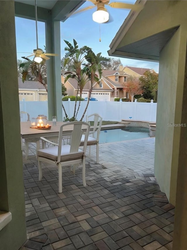 exterior space featuring ceiling fan, an outdoor fire pit, and a patio area