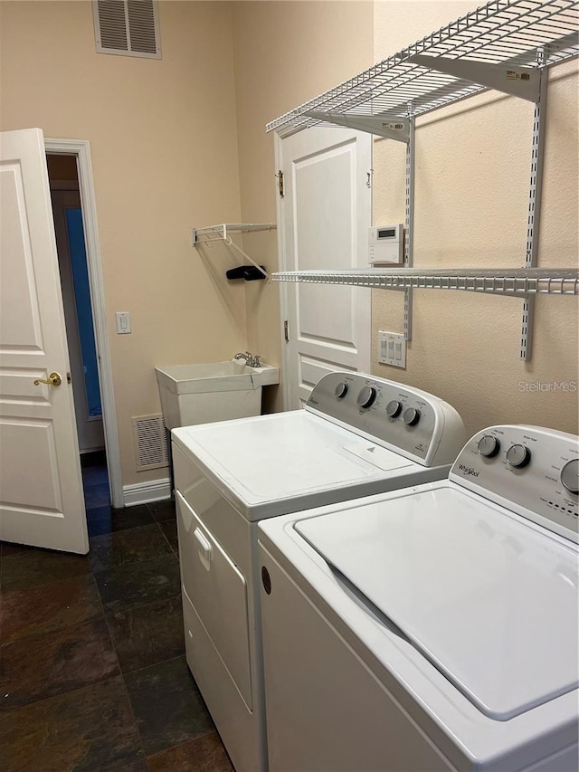 laundry area featuring washer and dryer and sink