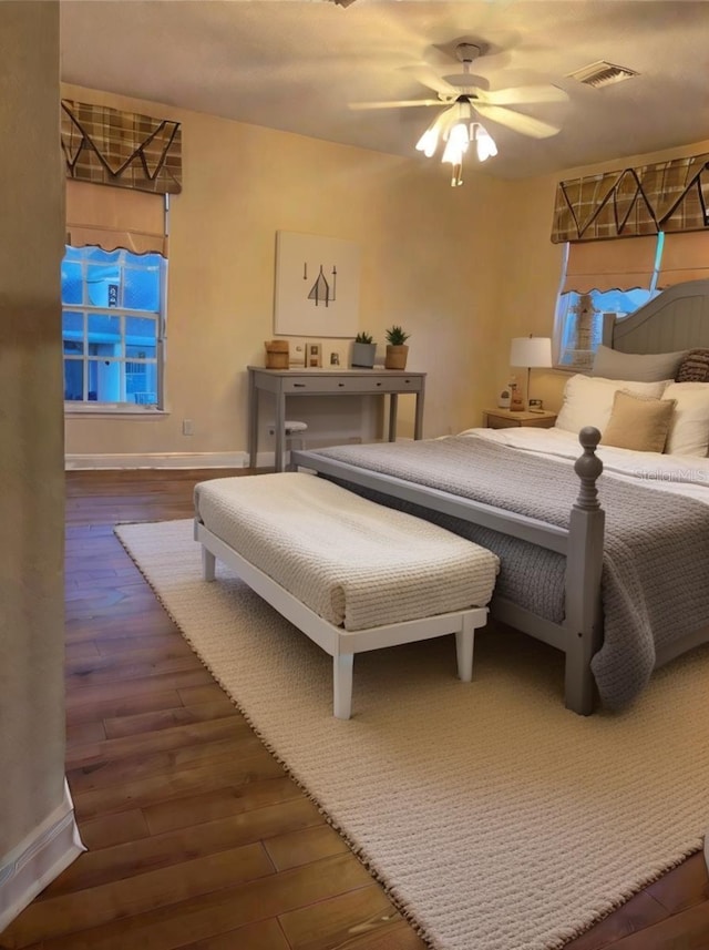 bedroom with ceiling fan and dark hardwood / wood-style flooring