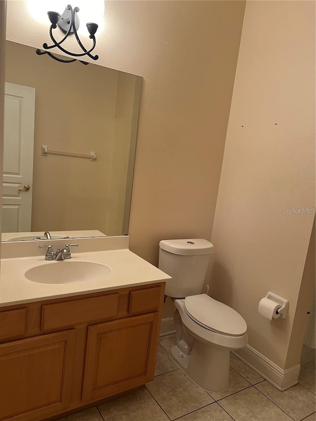 bathroom with tile patterned floors, toilet, and vanity