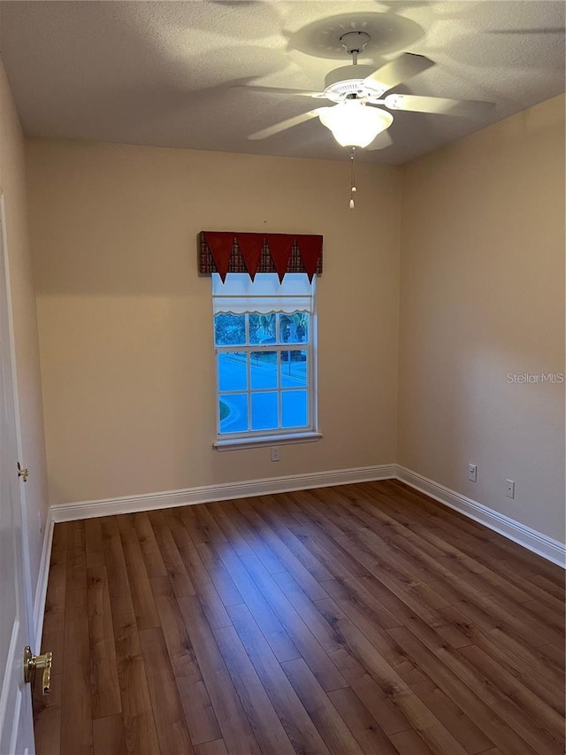 spare room with hardwood / wood-style floors, a textured ceiling, and ceiling fan