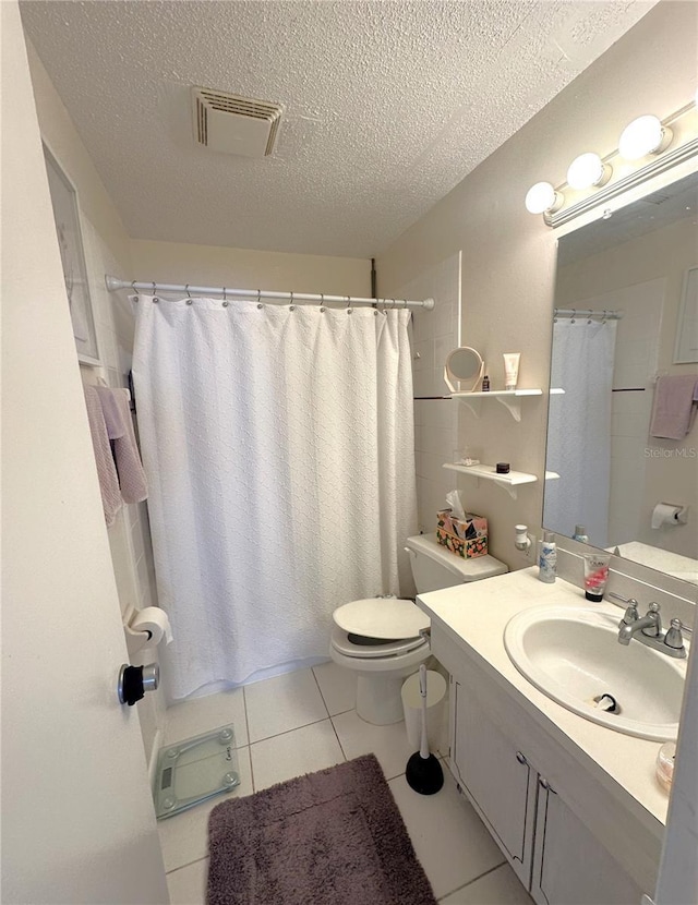 bathroom featuring visible vents, toilet, tile patterned floors, a textured ceiling, and vanity