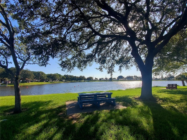 exterior space with a lawn and a water view