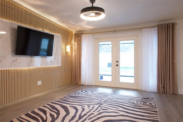 empty room featuring wood finished floors and french doors