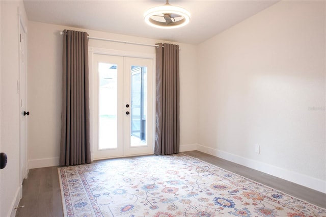 interior space featuring french doors, baseboards, and wood finished floors