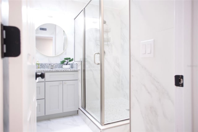 full bath with marble finish floor, visible vents, vanity, and a marble finish shower