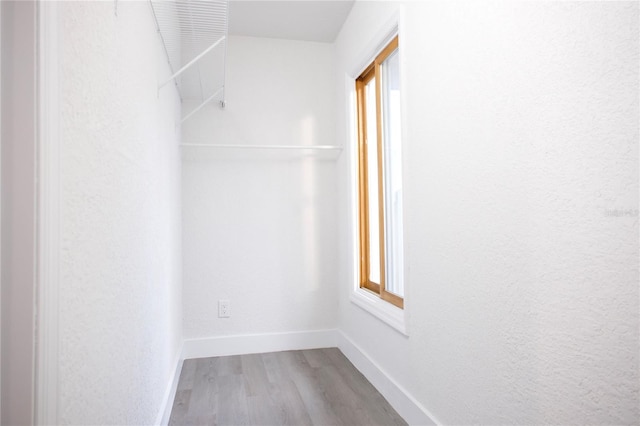 spacious closet featuring light wood-style flooring