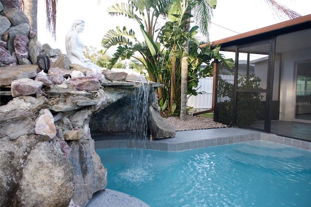 view of swimming pool with a fenced in pool and fence