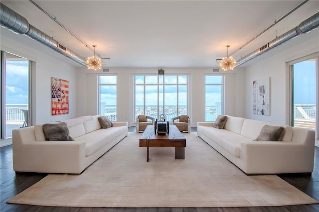 living room featuring hardwood / wood-style flooring and a notable chandelier