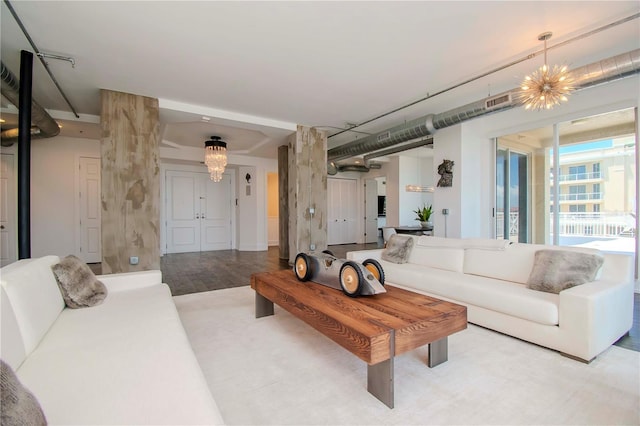 living room featuring wood-type flooring and a chandelier