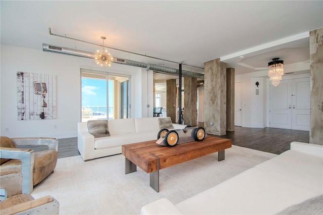 living room featuring a notable chandelier and light hardwood / wood-style floors