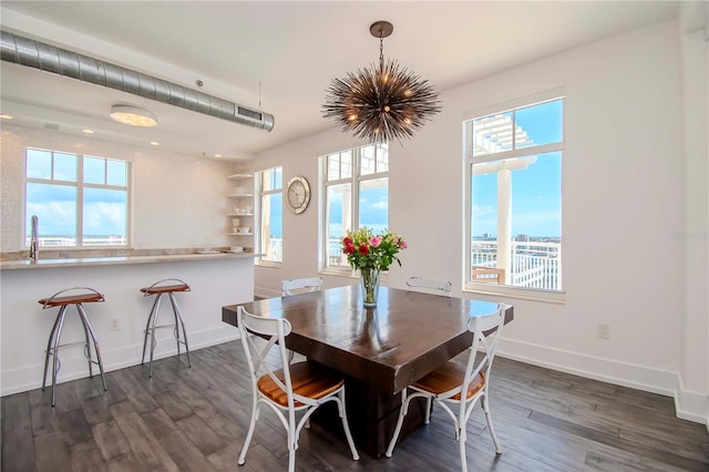 dining area featuring dark wood-type flooring and a wealth of natural light