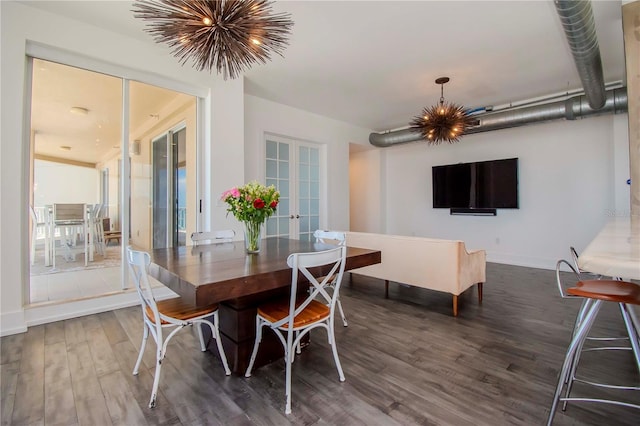 dining room with dark hardwood / wood-style flooring, french doors, and a chandelier