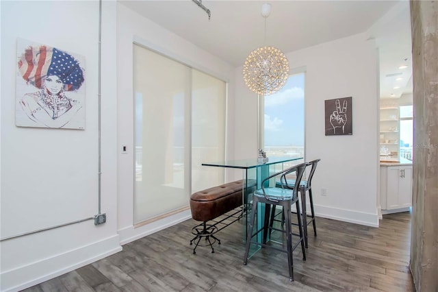 dining room featuring a notable chandelier and dark hardwood / wood-style floors