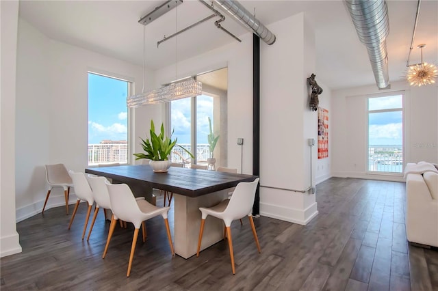 dining space featuring dark wood-type flooring and a wealth of natural light