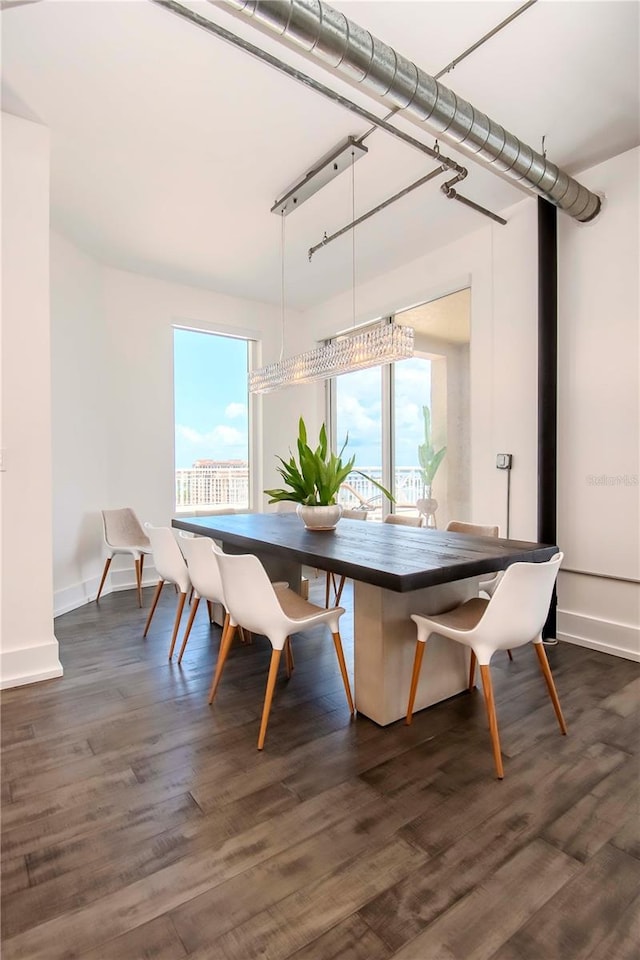 dining space with dark hardwood / wood-style floors