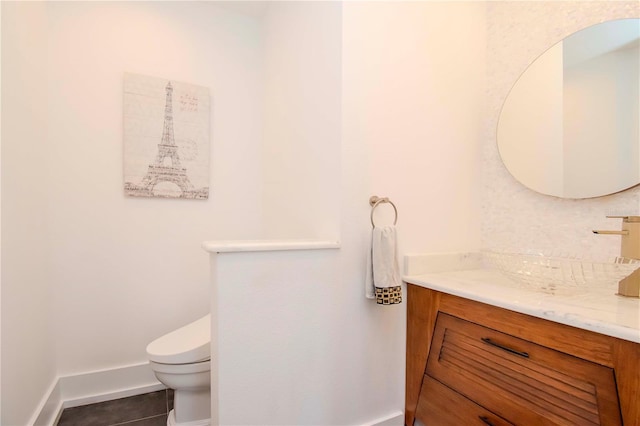 bathroom featuring vanity, tile patterned flooring, and toilet