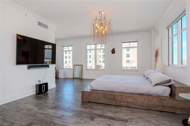 bedroom with crown molding, dark wood-type flooring, and a chandelier