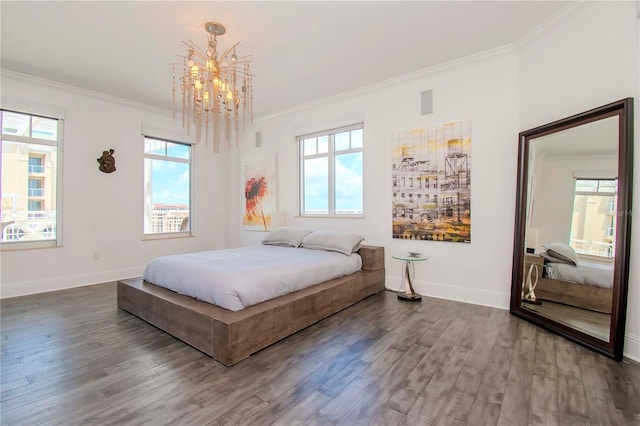 bedroom with an inviting chandelier, hardwood / wood-style floors, and crown molding