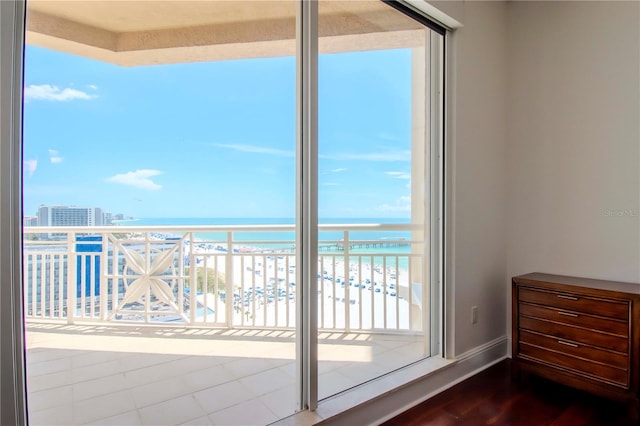 balcony with a water view and a beach view