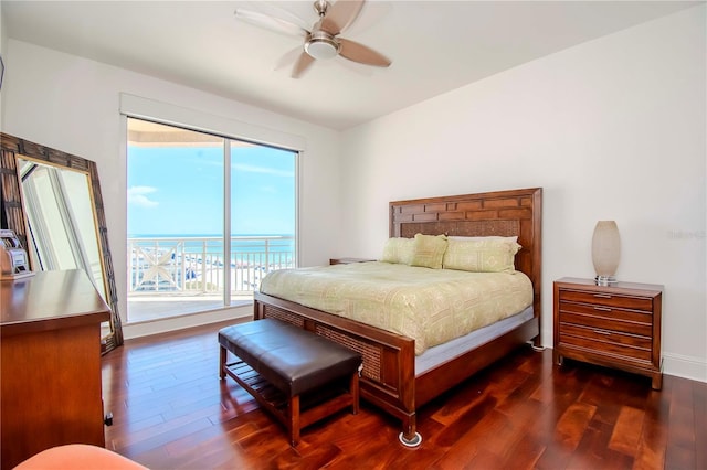 bedroom featuring a water view, ceiling fan, access to exterior, and dark wood-type flooring