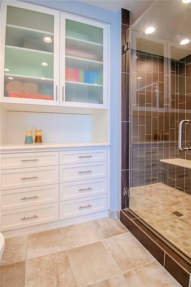 bathroom featuring an enclosed shower and tile patterned floors