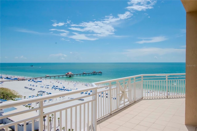 balcony featuring a water view and a beach view