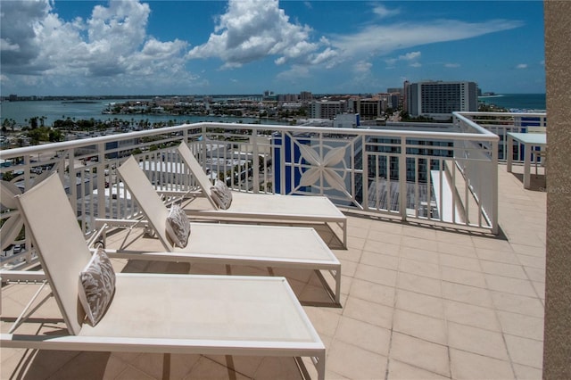 view of patio with a balcony and a water view