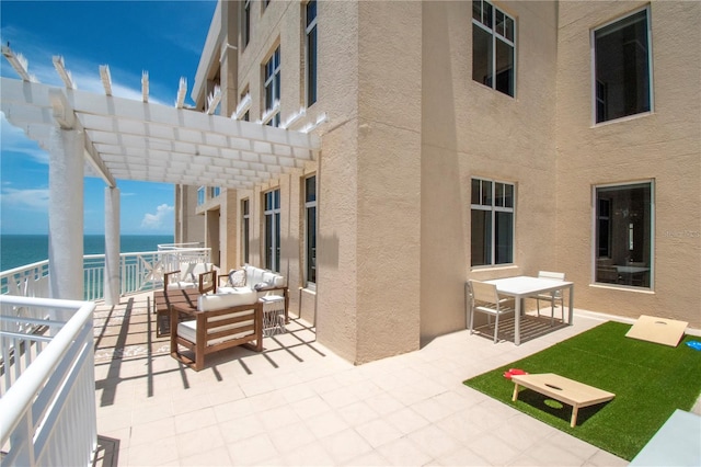 view of patio featuring an outdoor living space, a water view, and a pergola