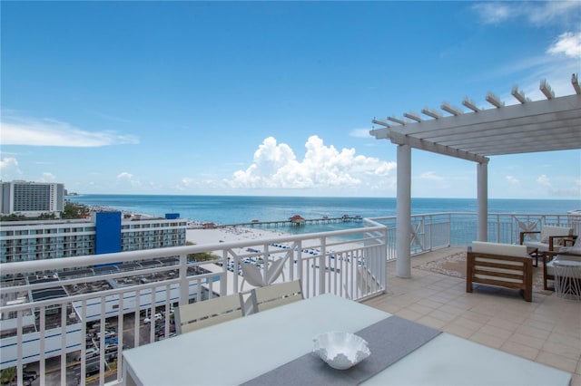 view of patio with a water view, an outdoor living space, a view of the beach, and a pergola