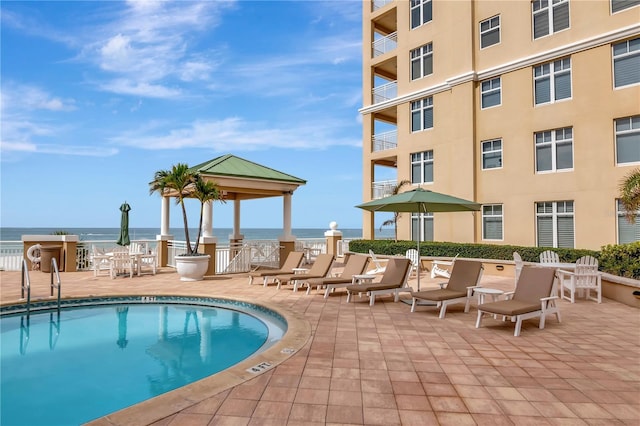 view of pool featuring a gazebo and a water view