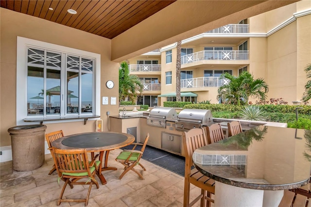 view of patio with a grill, exterior kitchen, and sink