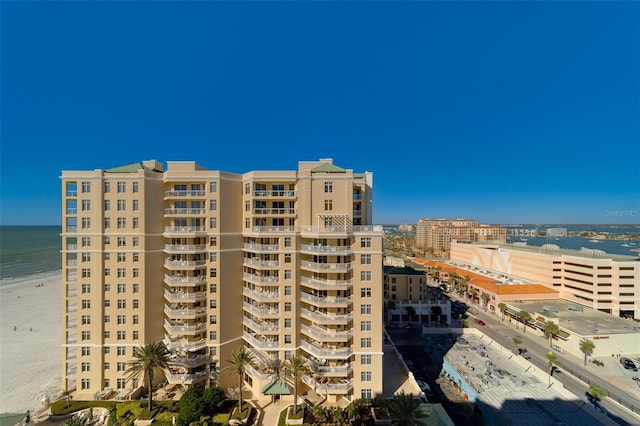 view of building exterior featuring a water view and a city view