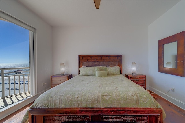 bedroom with baseboards and wood finished floors